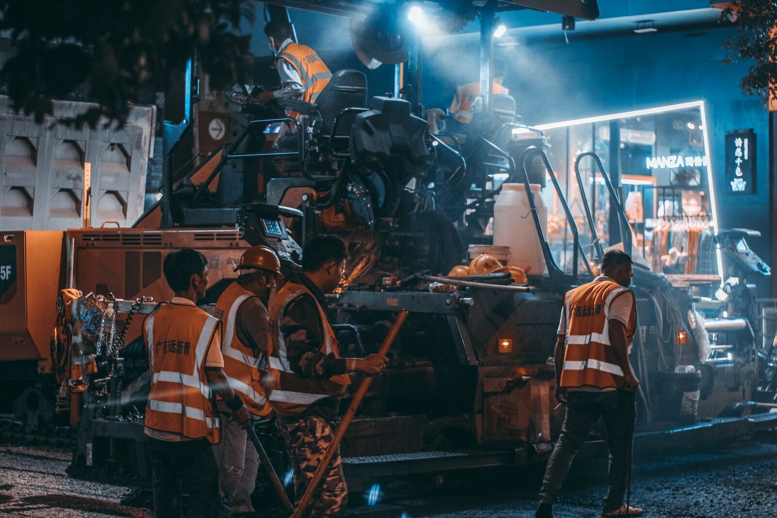 Workers Using Heavy Machine in Asphalt Laying